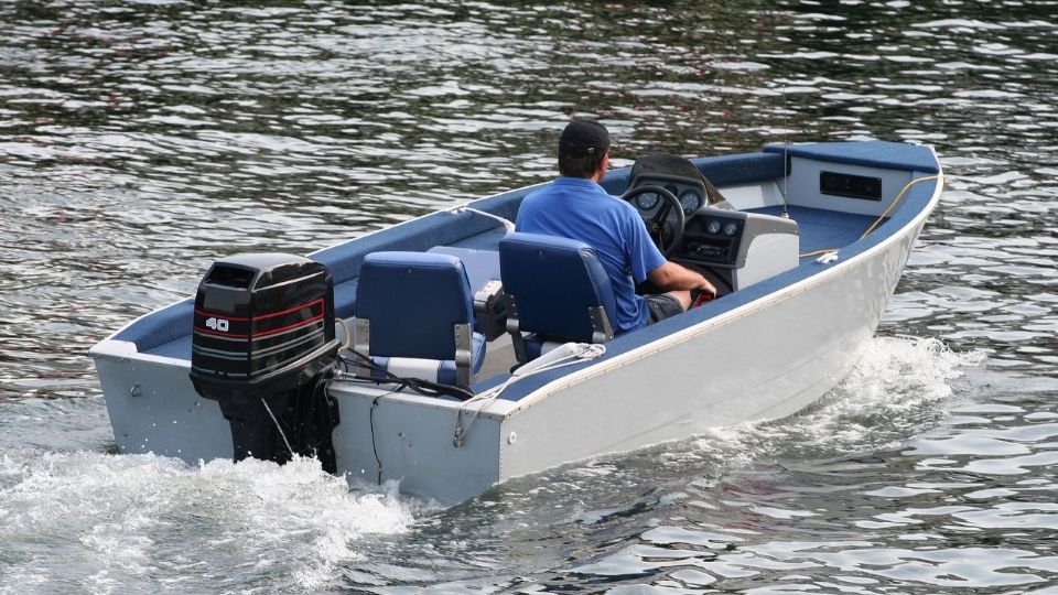 man on an outdoor motor boat